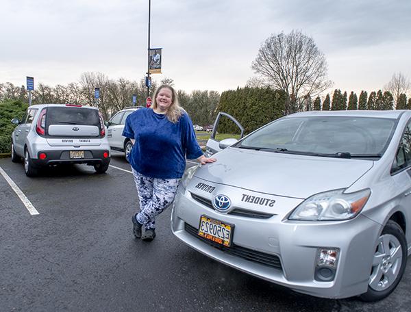 Photo of Leah Hanson with a driver's ed car